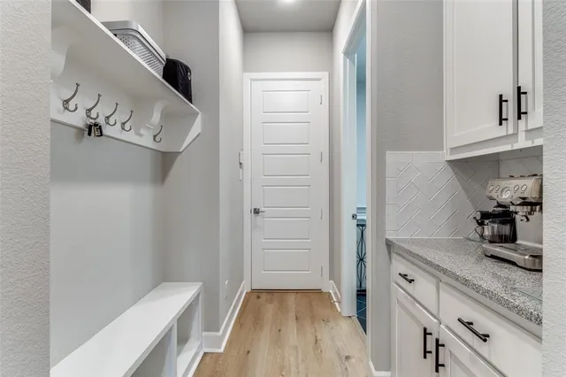 a kitchen with a refrigerator and cabinets