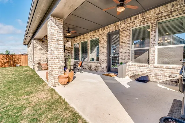 a view of a house with backyard outdoor seating area and barbeque oven