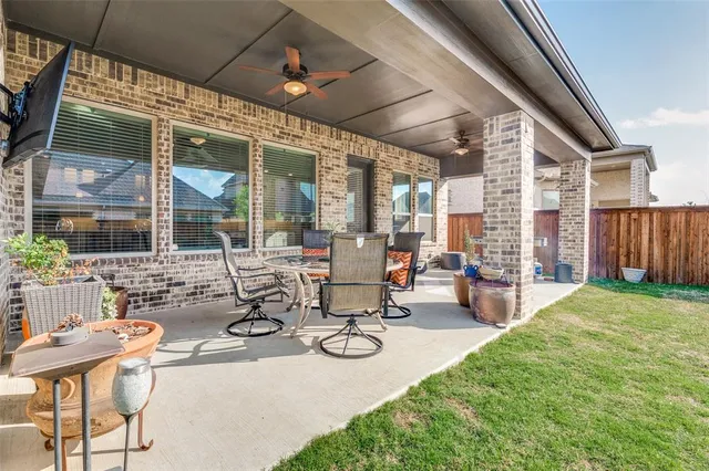a view of a patio with table and chairs and potted plants