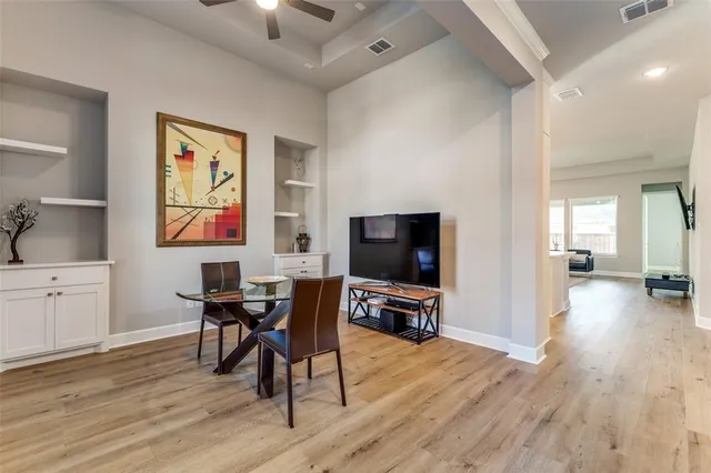 a view of a livingroom with furniture a flat screen tv and wooden floor