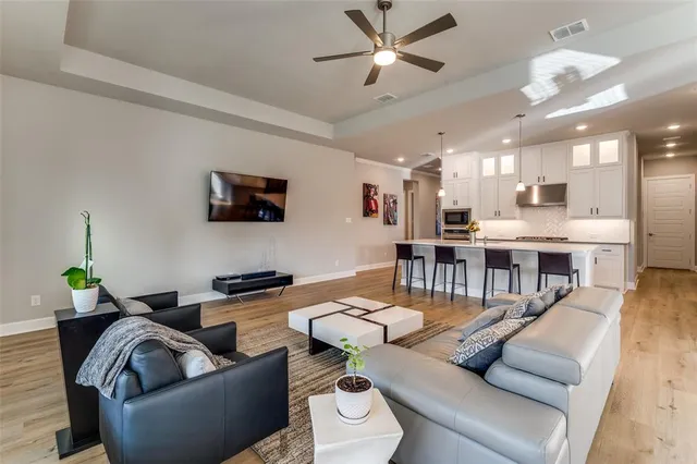 a living room with furniture and kitchen view