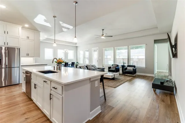a kitchen with sink stove and refrigerator