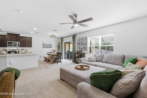 a living room with furniture and kitchen view