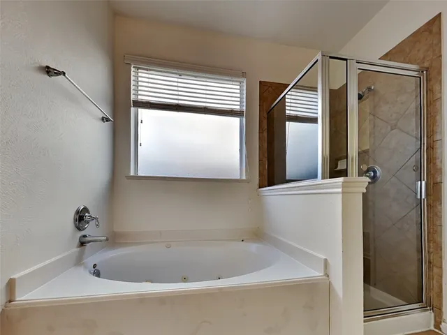 a view of a room with wooden floor and a ceiling fan