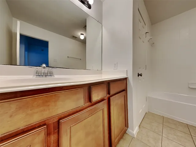 a view of a house with a patio and a yard