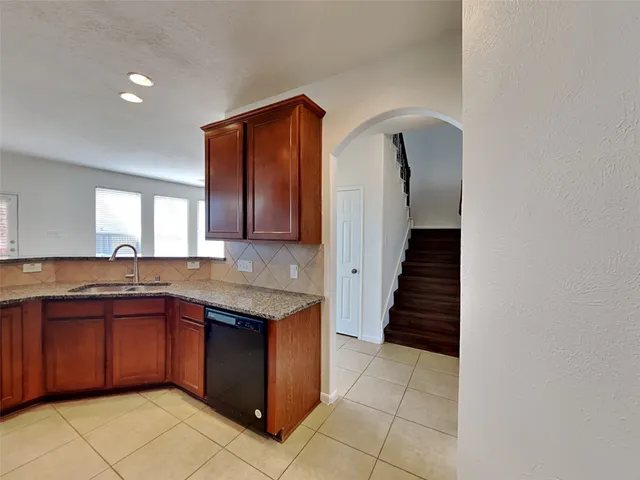 a kitchen with a sink a counter space and cabinets