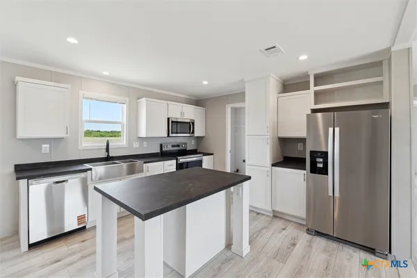 a kitchen with a refrigerator a sink and a stove