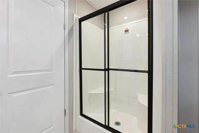a bathroom with a glass shower door