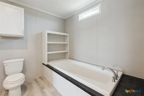 a bathroom with a toilet and a vanity