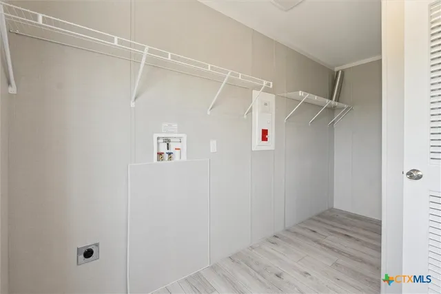 a view of walk in closet with empty racks