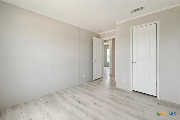a view of an empty room and wooden floor