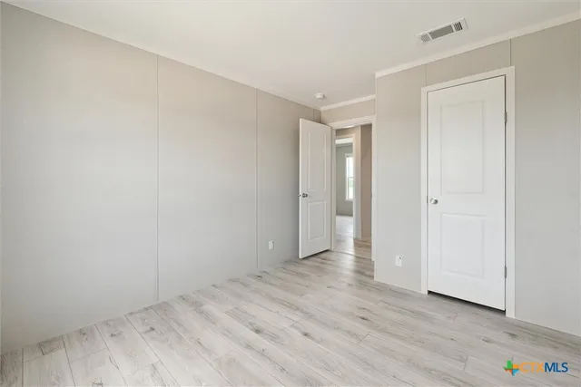 a view of an empty room and wooden floor