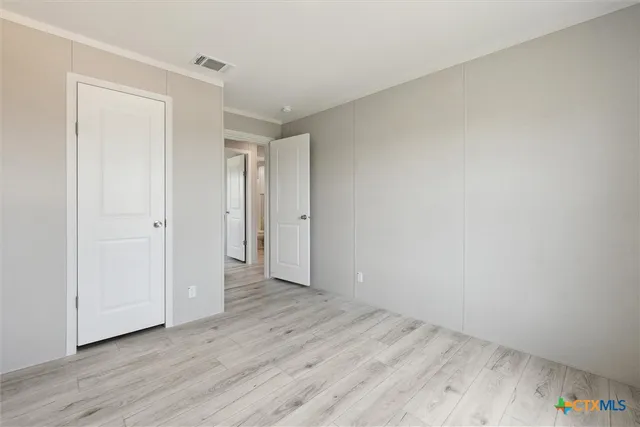 a view of an empty room and wooden floor