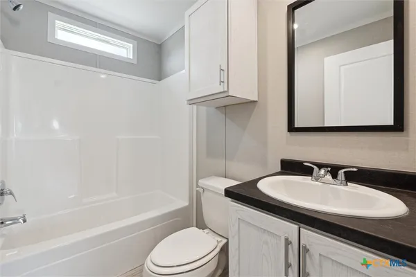 a bathroom with a sink a toilet and bathtub