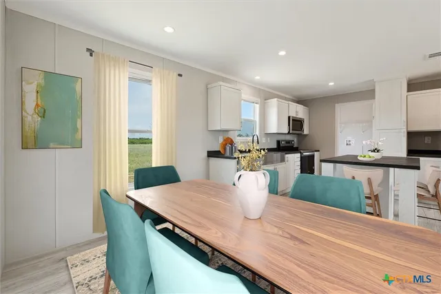 a kitchen with a table and chairs