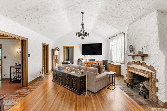 a living room with furniture flat screen tv and windows
