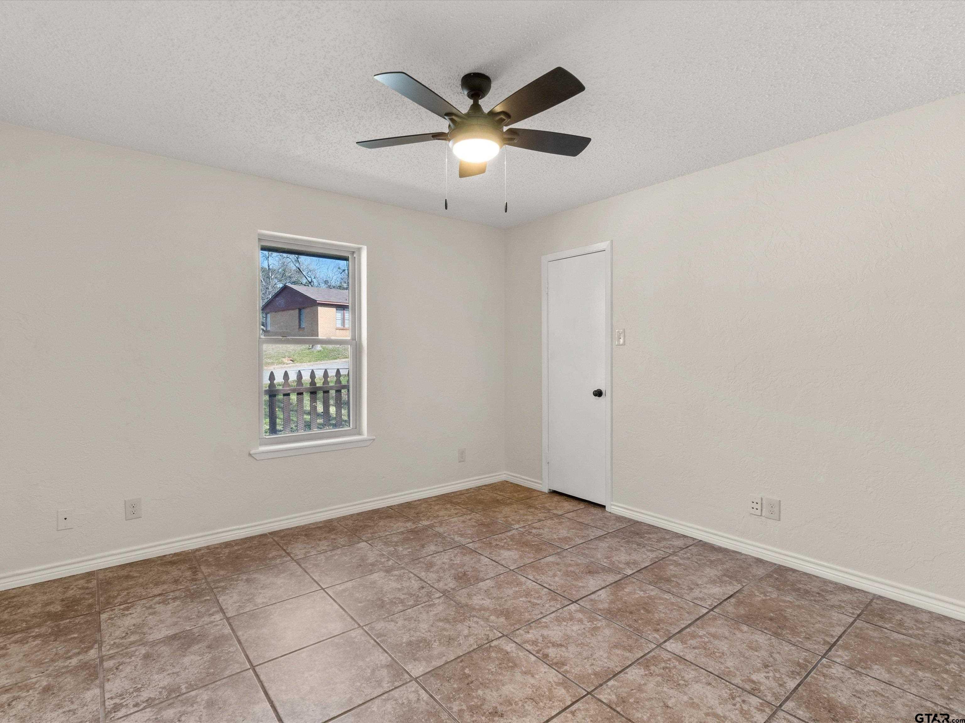 901 Skyview Drive Gilmer, TX 75644 - Photo 12 of 18 a view of an empty room with a ceiling fan