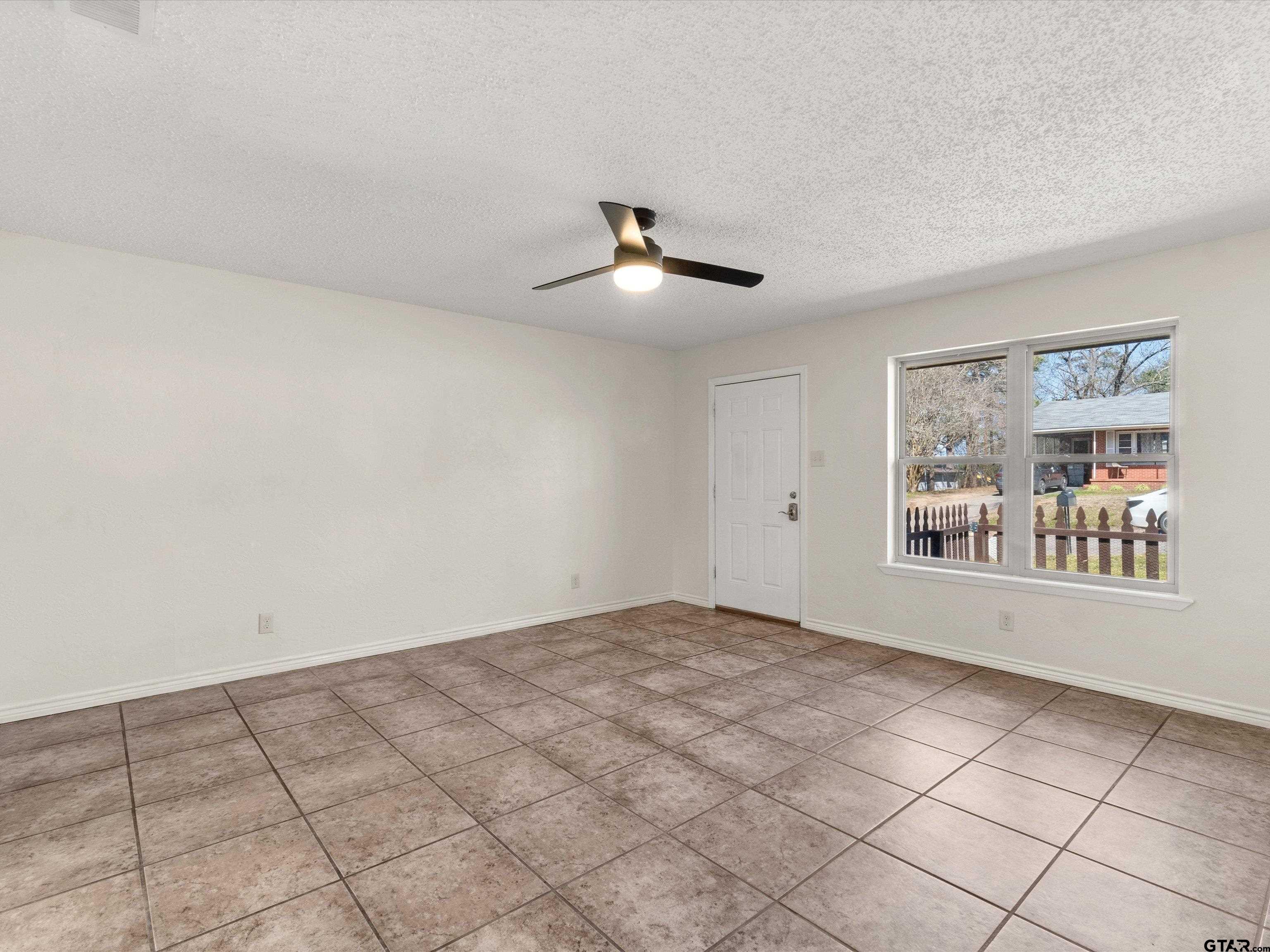 901 Skyview Drive Gilmer, TX 75644 - Photo 8 of 18 a view of an empty room with a window