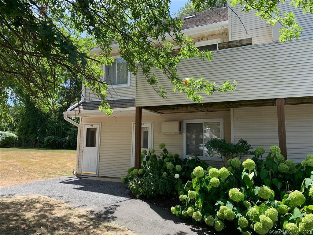 136 Pembroke Road, Unit 95 Danbury, CT 06811 - Photo 1 of 1 a front view of a house with garden