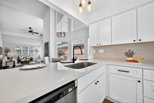 a kitchen with wooden floors and white appliances