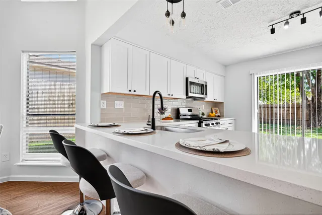 a dining room with furniture and wooden floor