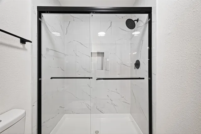 a bathroom with a double vanity sink mirror and shower