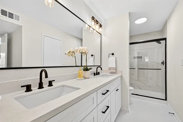 a bathroom with a shower and a mirror