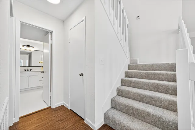 a bathroom with double vanity sink and mirror