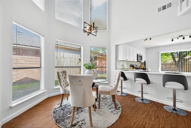 a view of a dining room with furniture window and wooden floor
