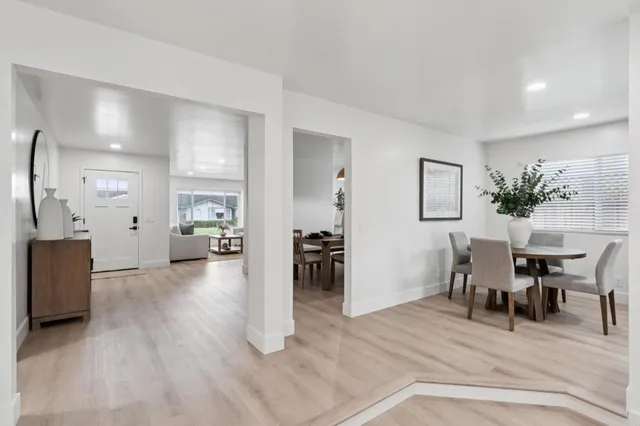 a view of a livingroom with furniture and kitchen view