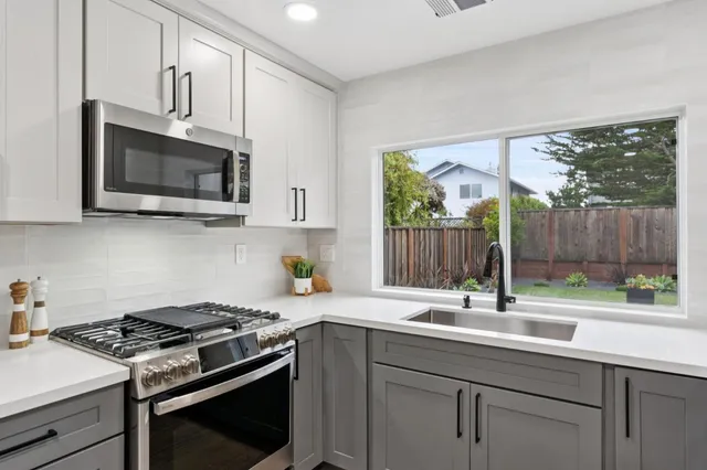 a kitchen with a stove a sink and a microwave