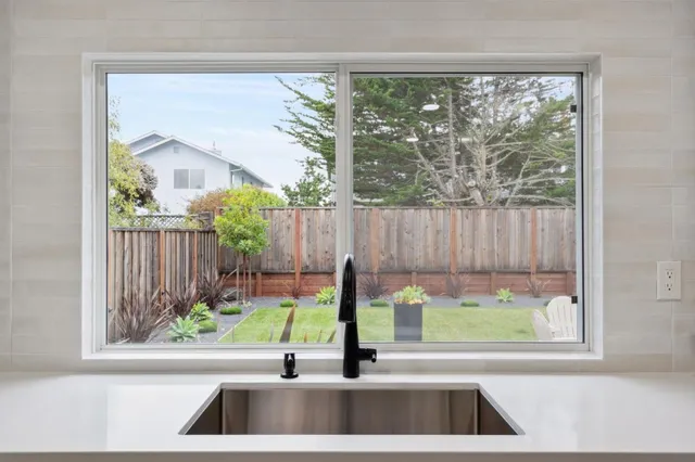 a view of a floor to ceiling window and a swimming pool