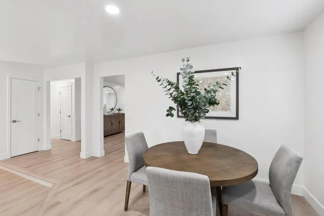 a dining room with furniture and wooden floor