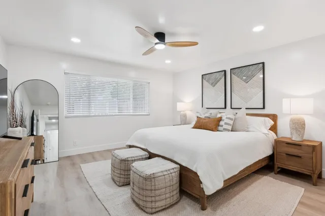 a bedroom with a bed and a flat screen tv