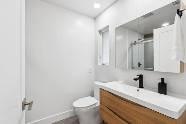 a bathroom with a sink a mirror and a shower