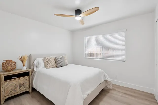 a bedroom with a bed and a window