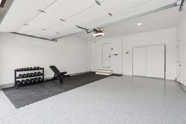 a view of a backyard with couches plants and large tree
