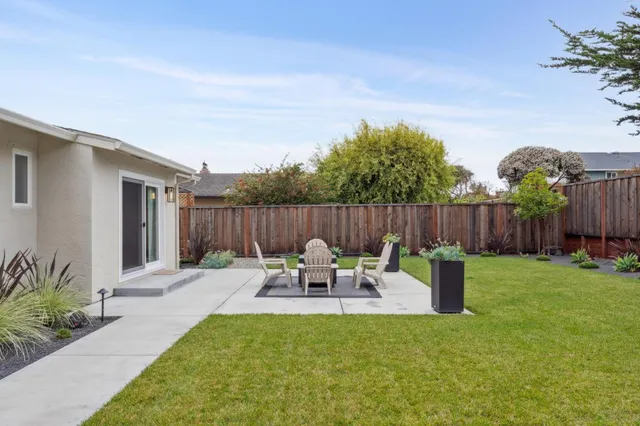 a front view of house with a garden and patio
