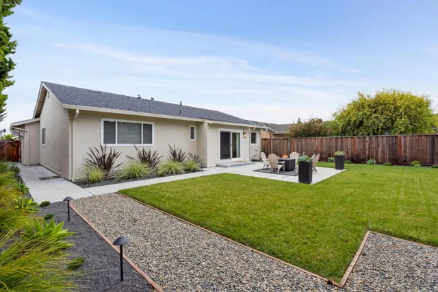 a house view with sitting space garden view with wooden fence