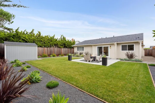 a view of a patio with table and chairs potted plants with wooden fence