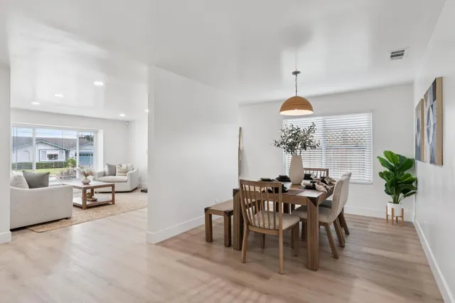 a view of a dining room with furniture window and wooden floor