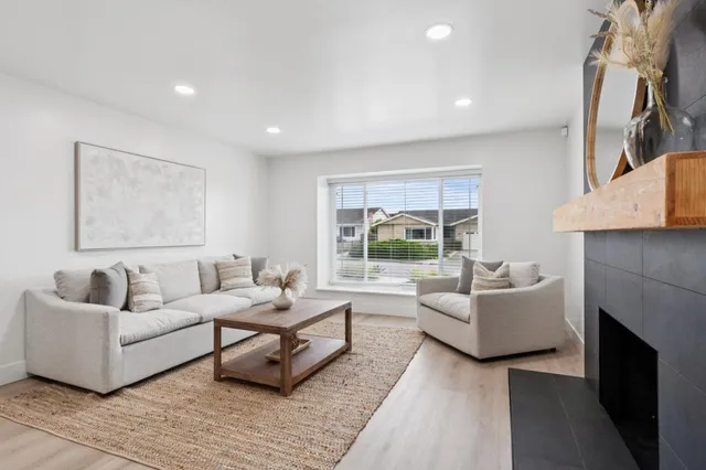 a living room with furniture and a fireplace