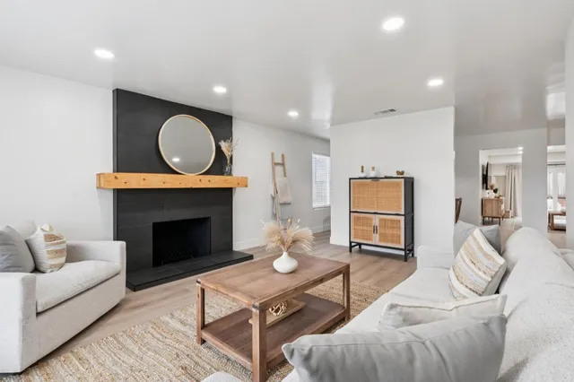 a living room with furniture a fireplace with wooden floor