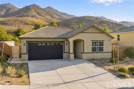 20565 Lost Creek Road Riverside, CA 92507 - Photo 1 of 32 a front view of a house with a yard and mountain view in back