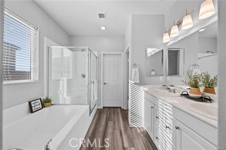 20565 Lost Creek Road Riverside, CA 92507 - Photo 13 of 32 a bathroom with a sink a bathtub a mirror and a shower