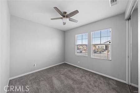 20565 Lost Creek Road Riverside, CA 92507 - Photo 16 of 32 an empty room with ceiling fan and windows