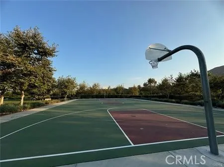 a view of backyard of couches and table and chairs under an umbrella