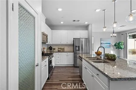 a kitchen with refrigerator and cabinets