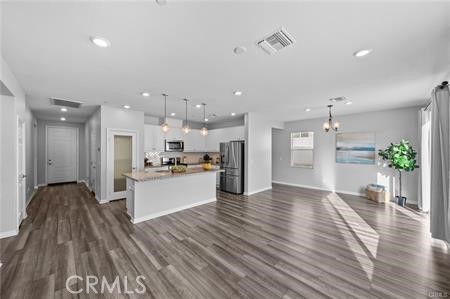 20565 Lost Creek Road Riverside, CA 92507 - Photo 6 of 32 a view of kitchen with kitchen island wooden floor center island and stainless steel appliances