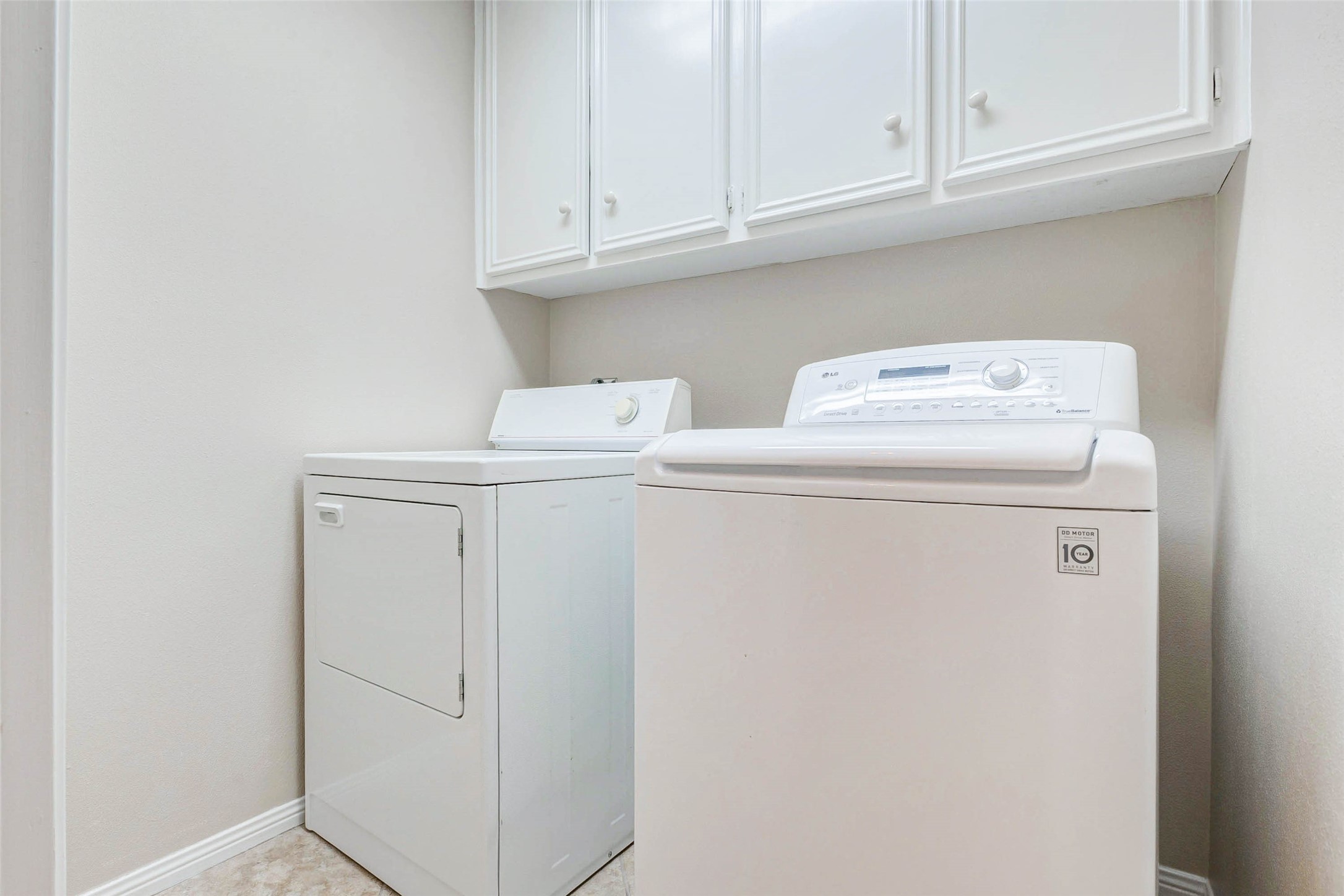 15811 Spring Forest Drive Houston, TX 77059 - Photo 22 of 27 This bright and efficient utility room offers ample storage with sleek white cabinets and modern appliances, making laundry a breeze.